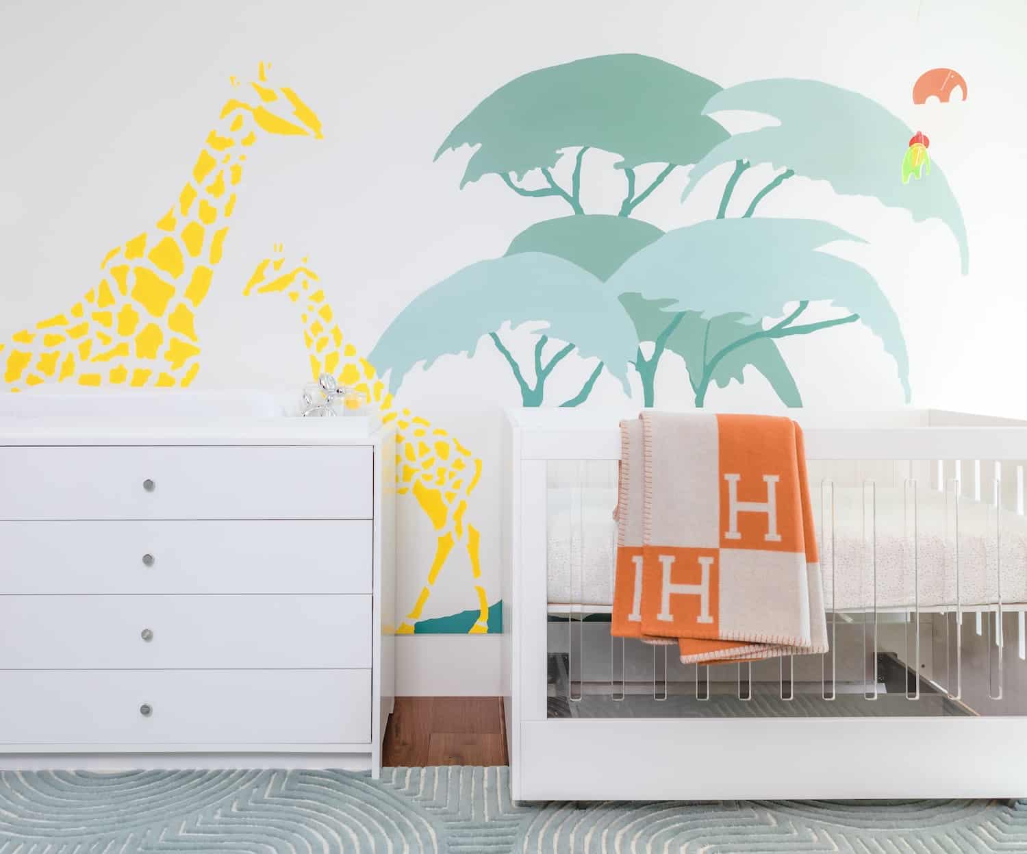 Colorful Modern Safari Nursery Design with Giraffe Mural