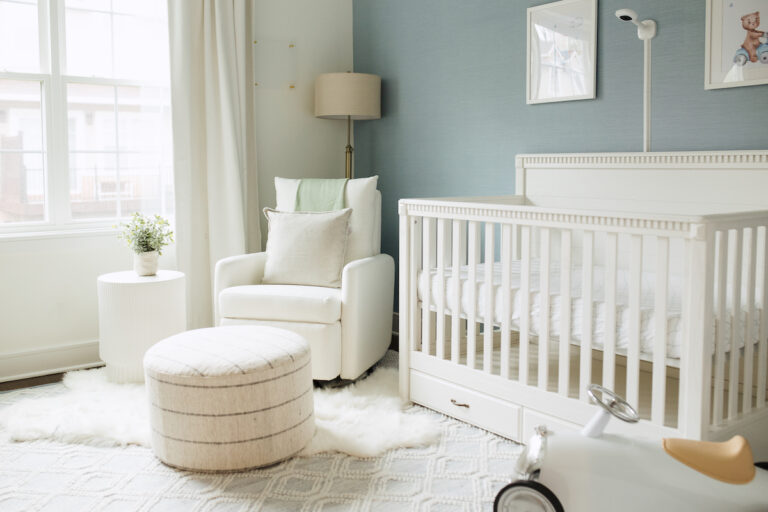 A light blue boy's nursery with grasscloth wallpaper
